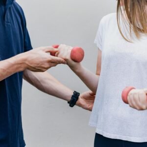 a man and a woman holding dumbs in their hands